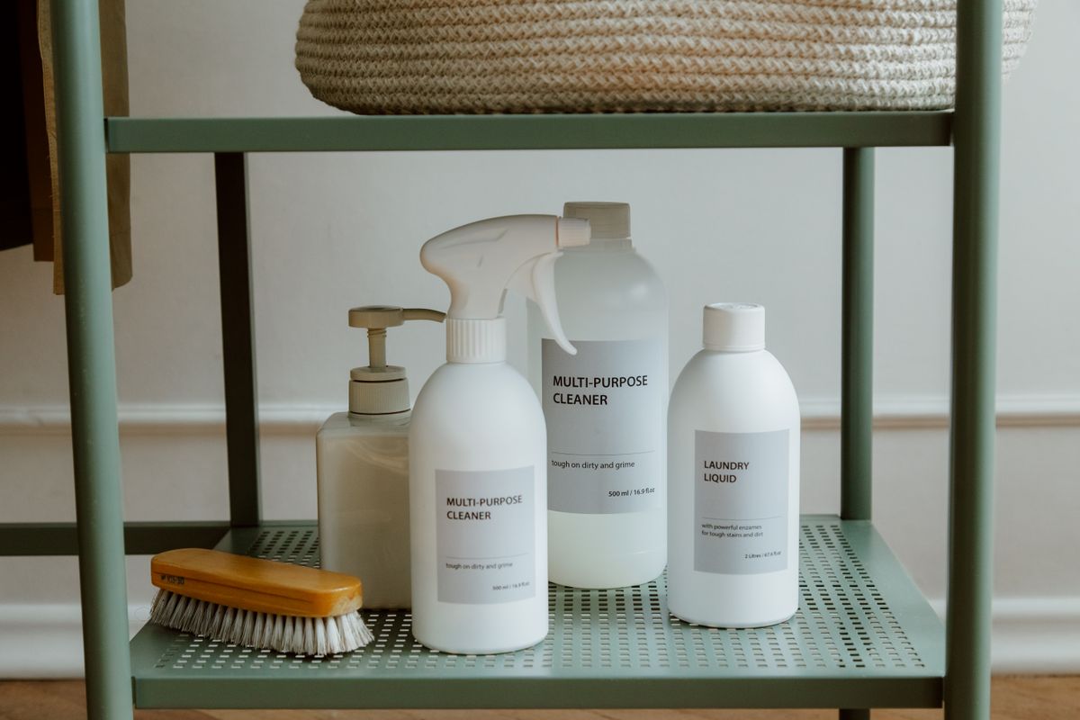 Assorted cleaning product bottles arranged on a clean surface