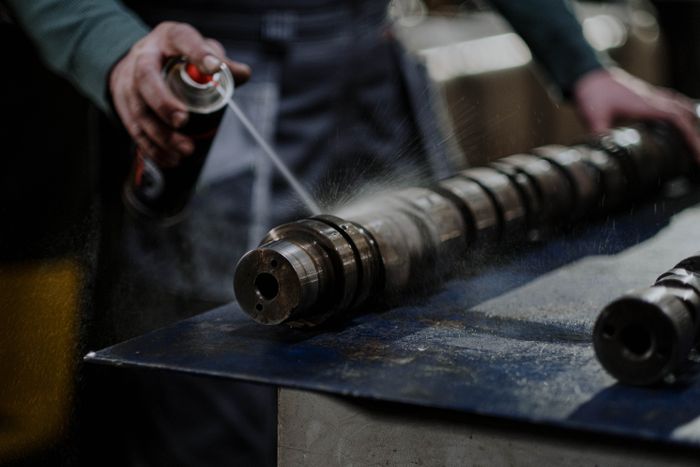 Greasy engine parts in a workshop illustrating heavy-duty degreasing needs