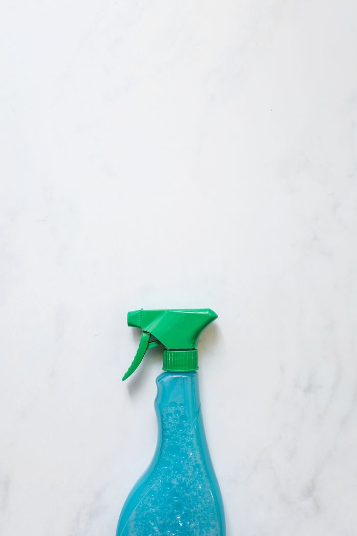 A blue spray bottle shown against a plain white background